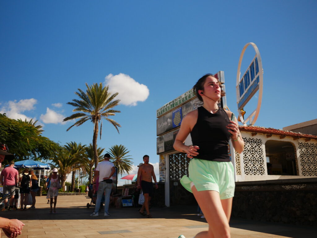 Runner on beach promenade San Agustin Gran Canaria