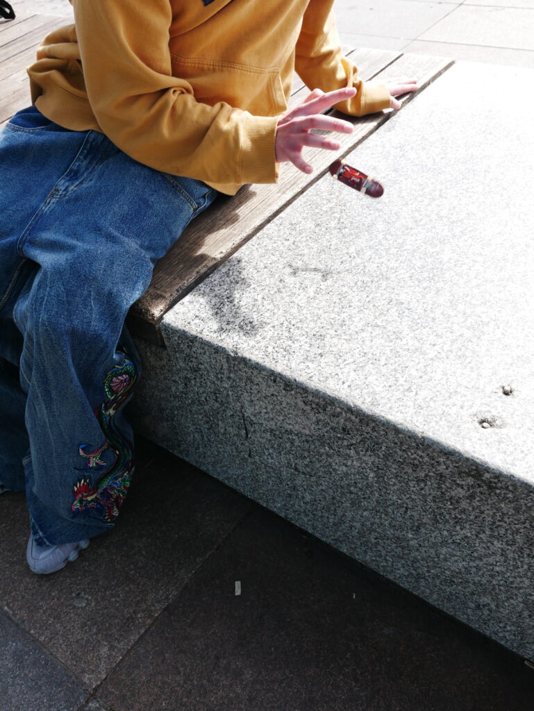 Skateboarder playing with a finger board